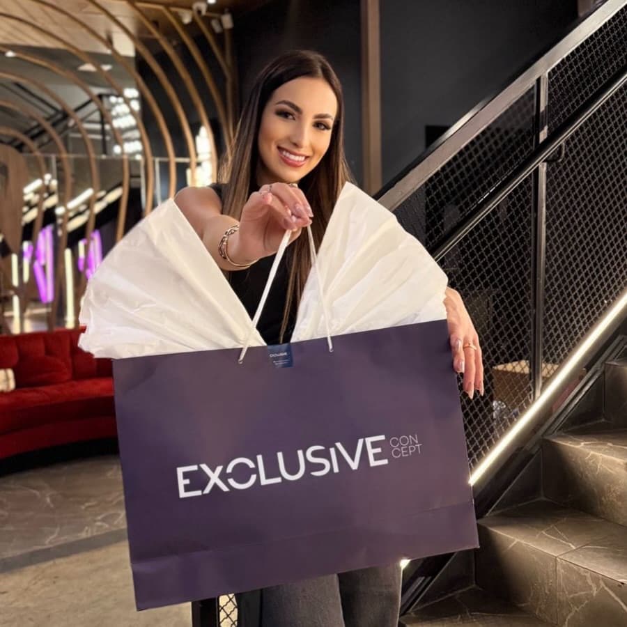 Cliente da Exclusive Conceptt com a sacola da loja